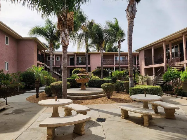 a view of a patio with couches and a table and chairs with plants
