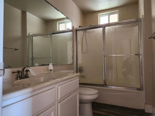 a bathroom with a sink a mirror and a shower
