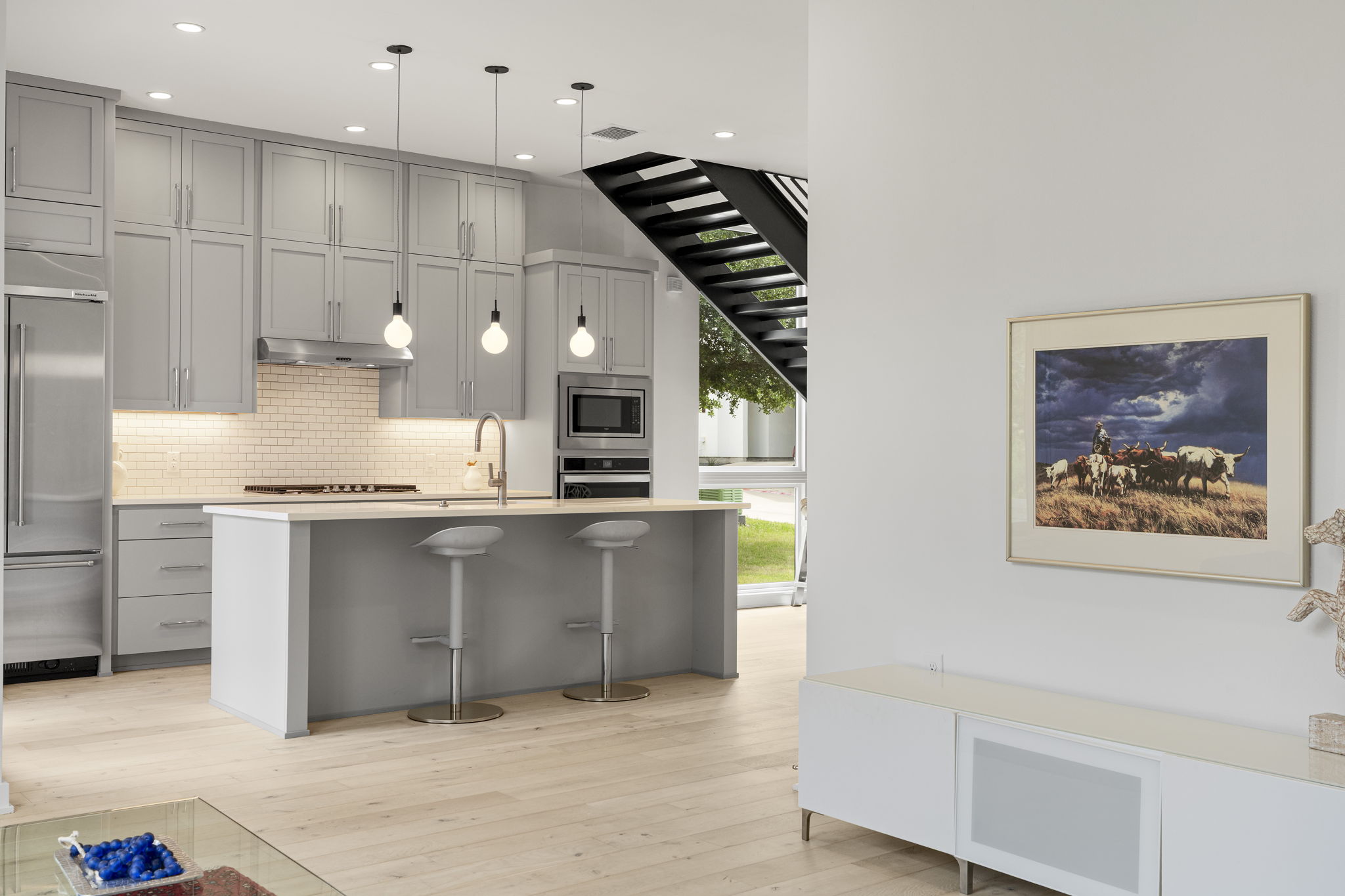 2520 Sutherland Street Austin, TX 78746 - Photo 6 of 26 A sleek island kitchen featuring state-of-the-art stainless steel appliances and abundant cabinetry.