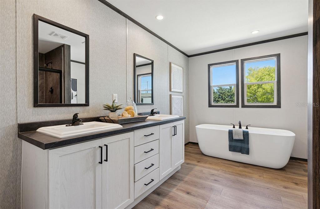 1089 Aspen Street Bunnell, FL 32110 - Photo 11 of 15 a spacious bathroom with a double vanity sink a mirror and a bathtub
