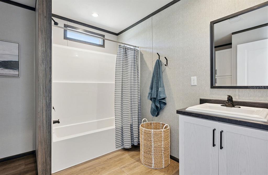 1089 Aspen Street Bunnell, FL 32110 - Photo 13 of 15 a bathroom with a sink and mirror with bathtub