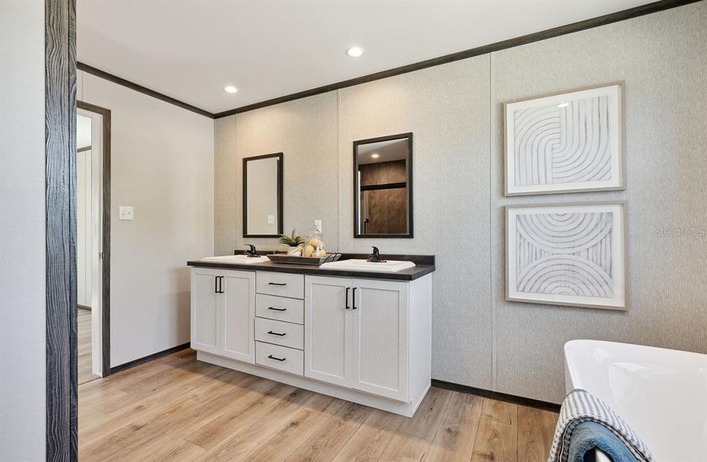 1089 Aspen Street Bunnell, FL 32110 - Photo 14 of 15 a bathroom with 2 sink tub and a mirror