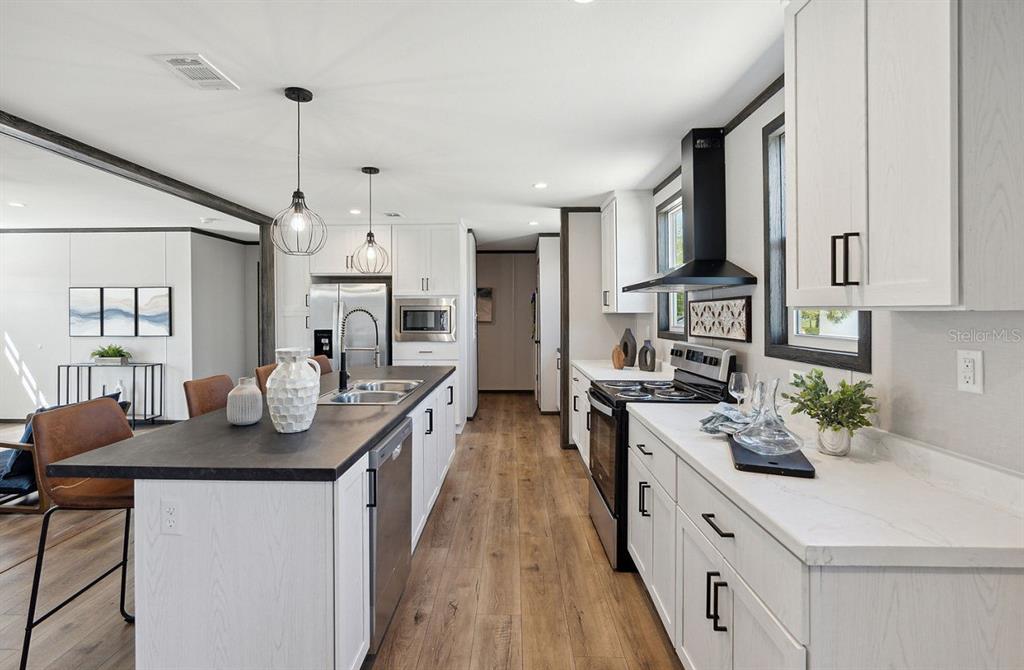 1089 Aspen Street Bunnell, FL 32110 - Photo 9 of 15 a kitchen with stainless steel appliances granite countertop a sink stove and refrigerator