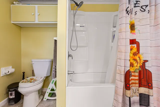 a bathroom with a toilet and shower