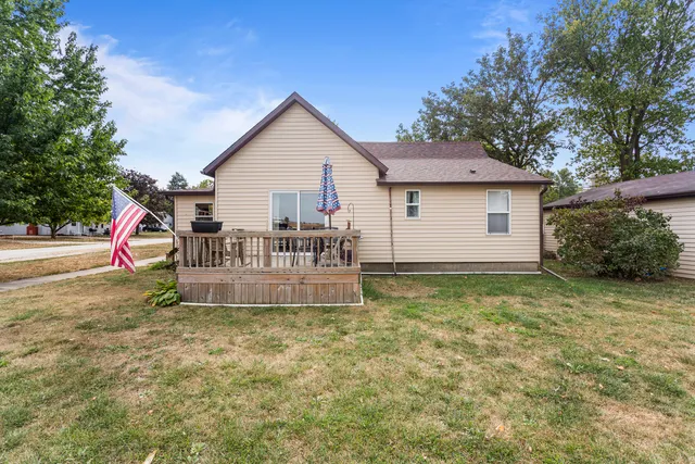 a view of a house with a yard and sitting area