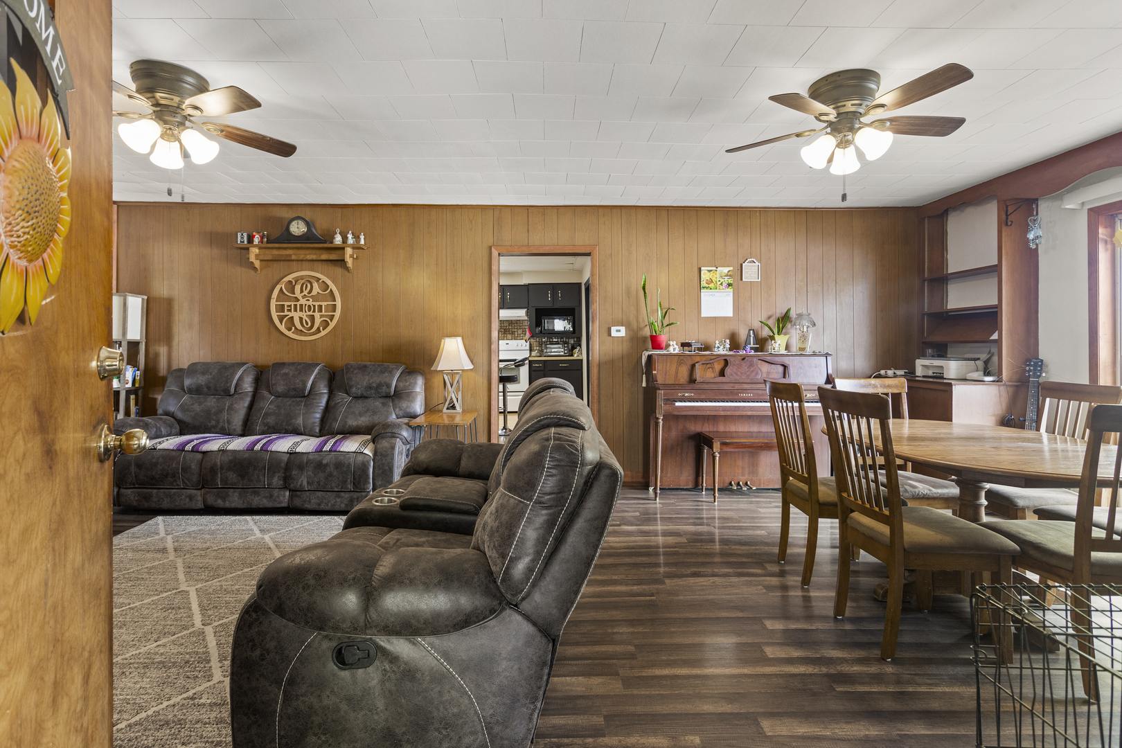 13 Willow Street Dewey, IL 61840 - Photo 8 of 27 a living room with furniture and a chandelier