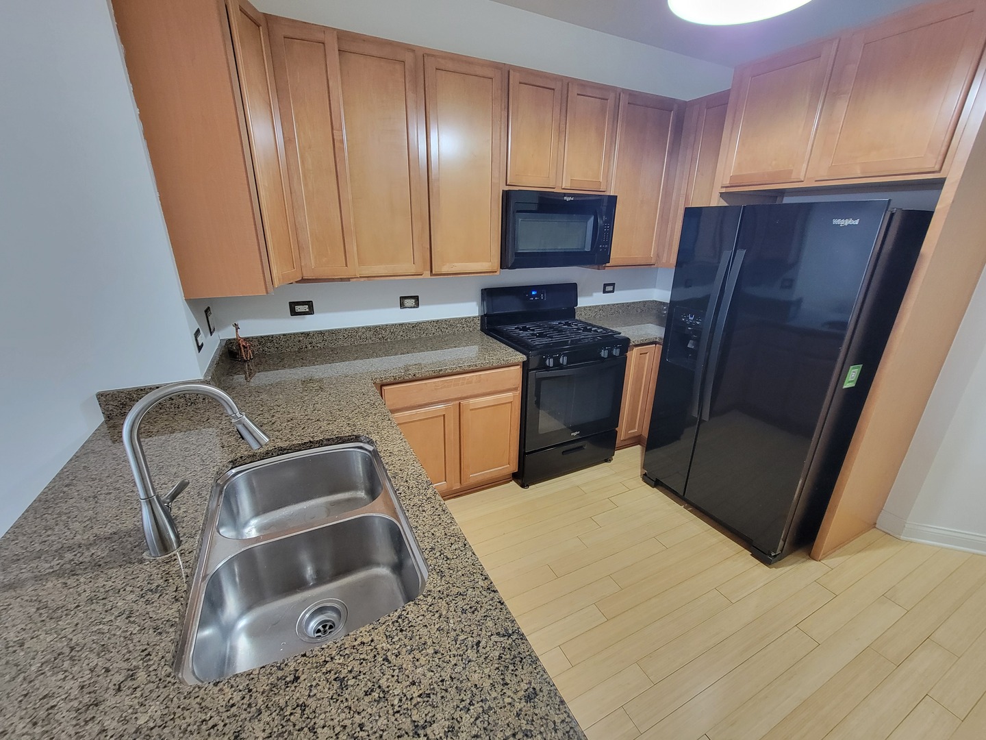 8 West Monroe Street, Unit 1508 Chicago, IL 60603 - Photo 12 of 25 a kitchen with stainless steel appliances granite countertop a refrigerator sink and stove