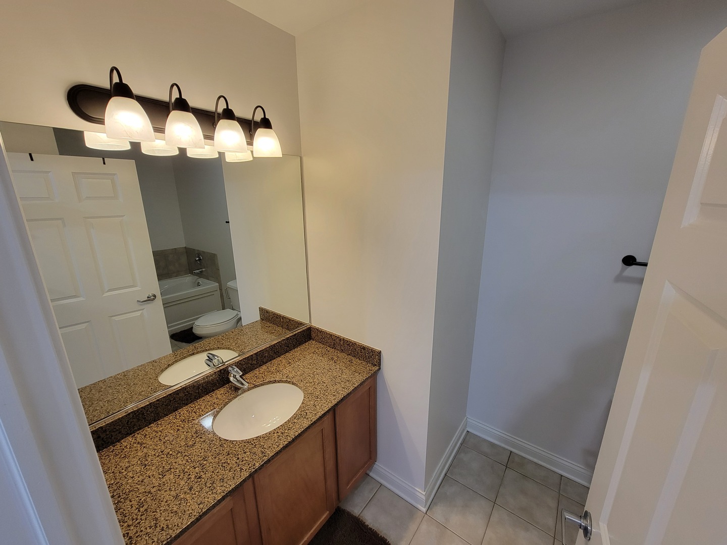 8 West Monroe Street, Unit 1508 Chicago, IL 60603 - Photo 6 of 25 a bathroom with a granite countertop sink and a mirror