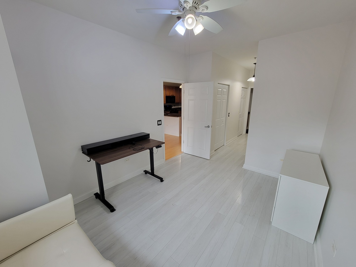 8 West Monroe Street, Unit 1508 Chicago, IL 60603 - Photo 10 of 25 a view of an empty room with wooden floor and fan