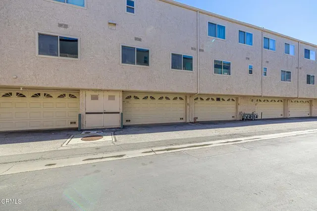 a view of a chairs and table under an umbrella in patio
