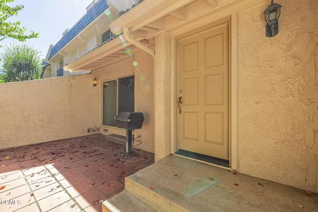 a view of a hallway with wooden floor and entryway