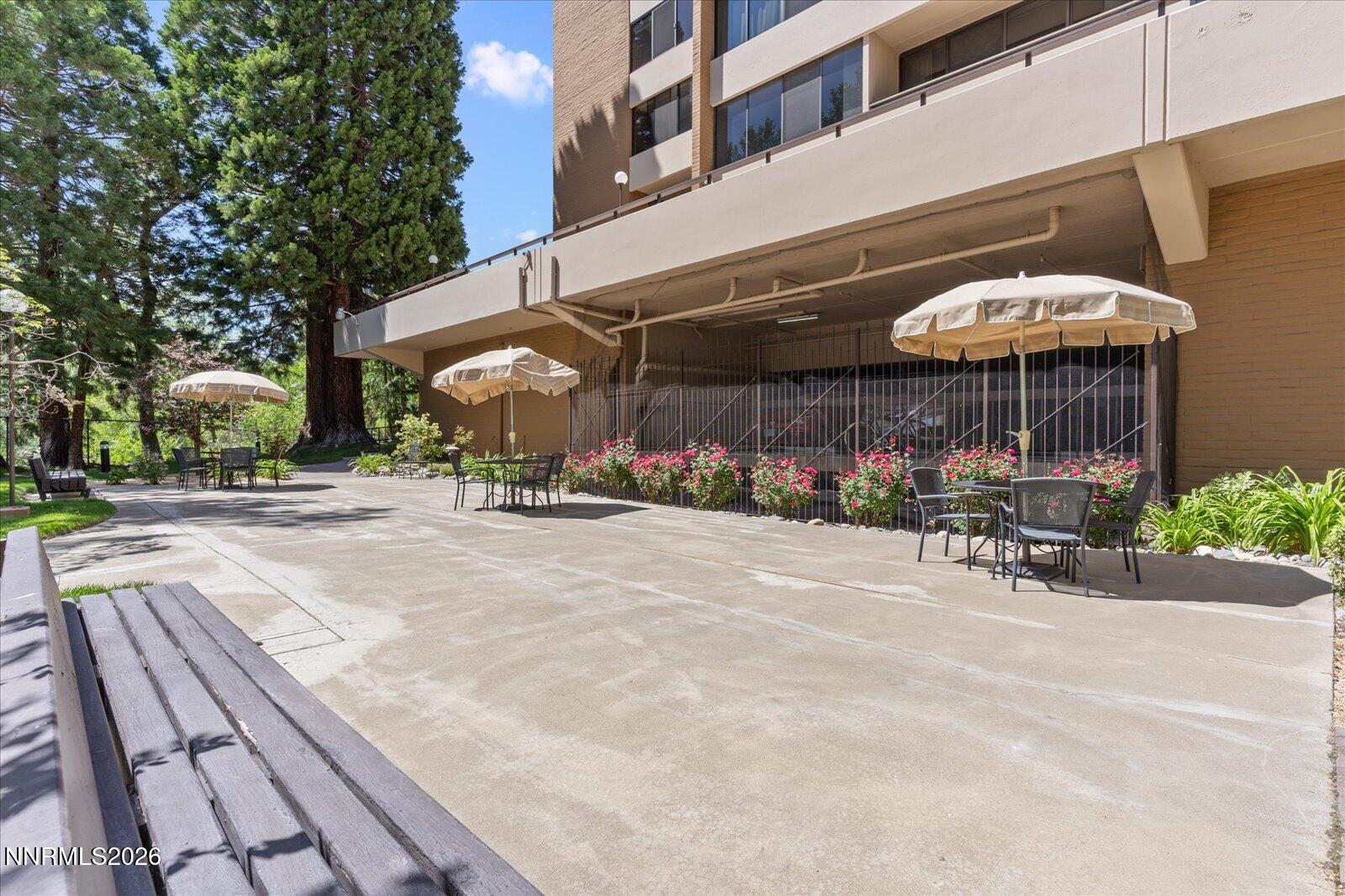 1200 Riverside Drive, Unit 1229 Reno, NV 89503 - Photo 45 of 51 a view of a patio with a table and chairs under an umbrella