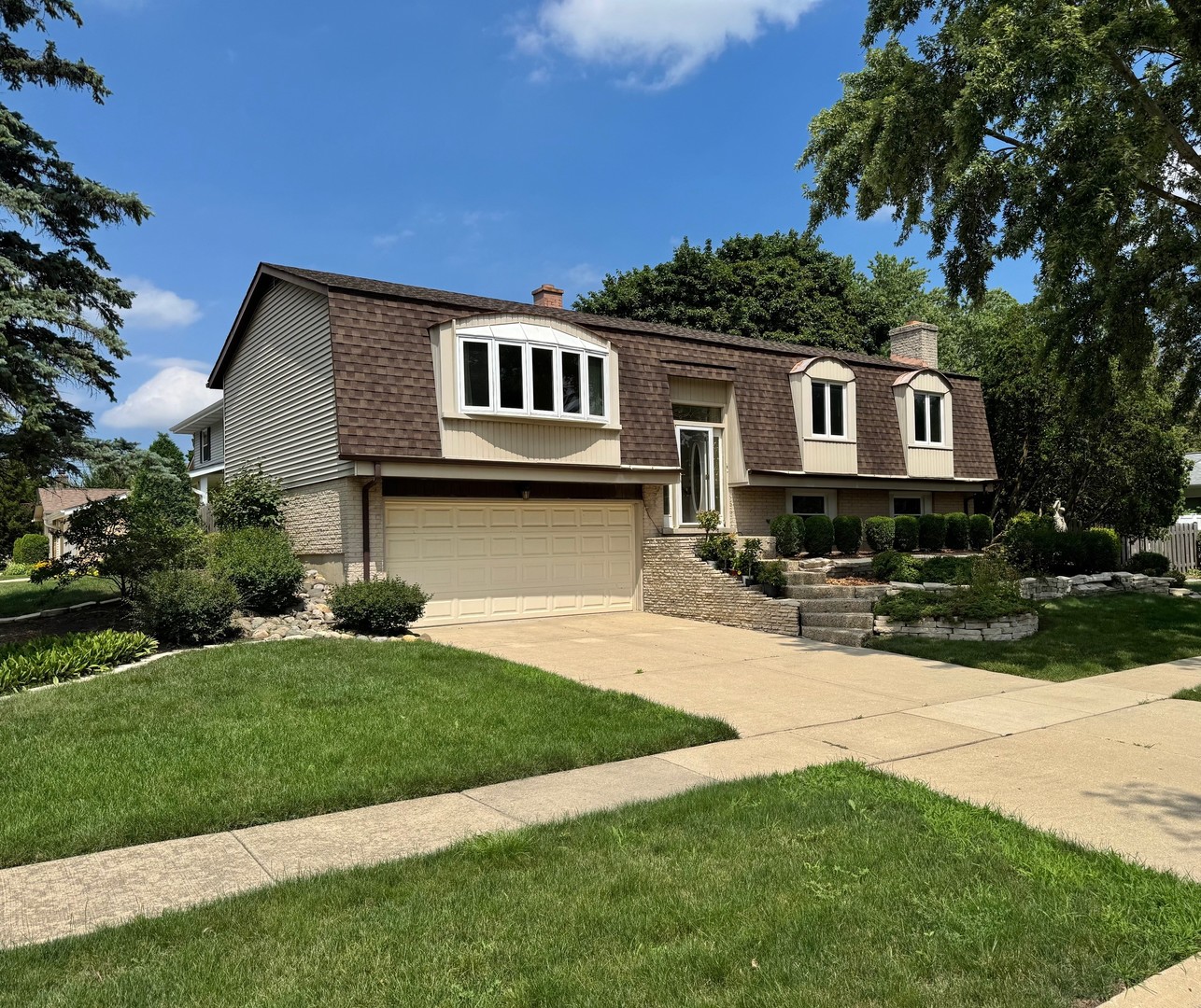 416 Trinity Court Buffalo Grove, IL 60089 - Photo 61 of 87 a front view of a house with a yard and garage