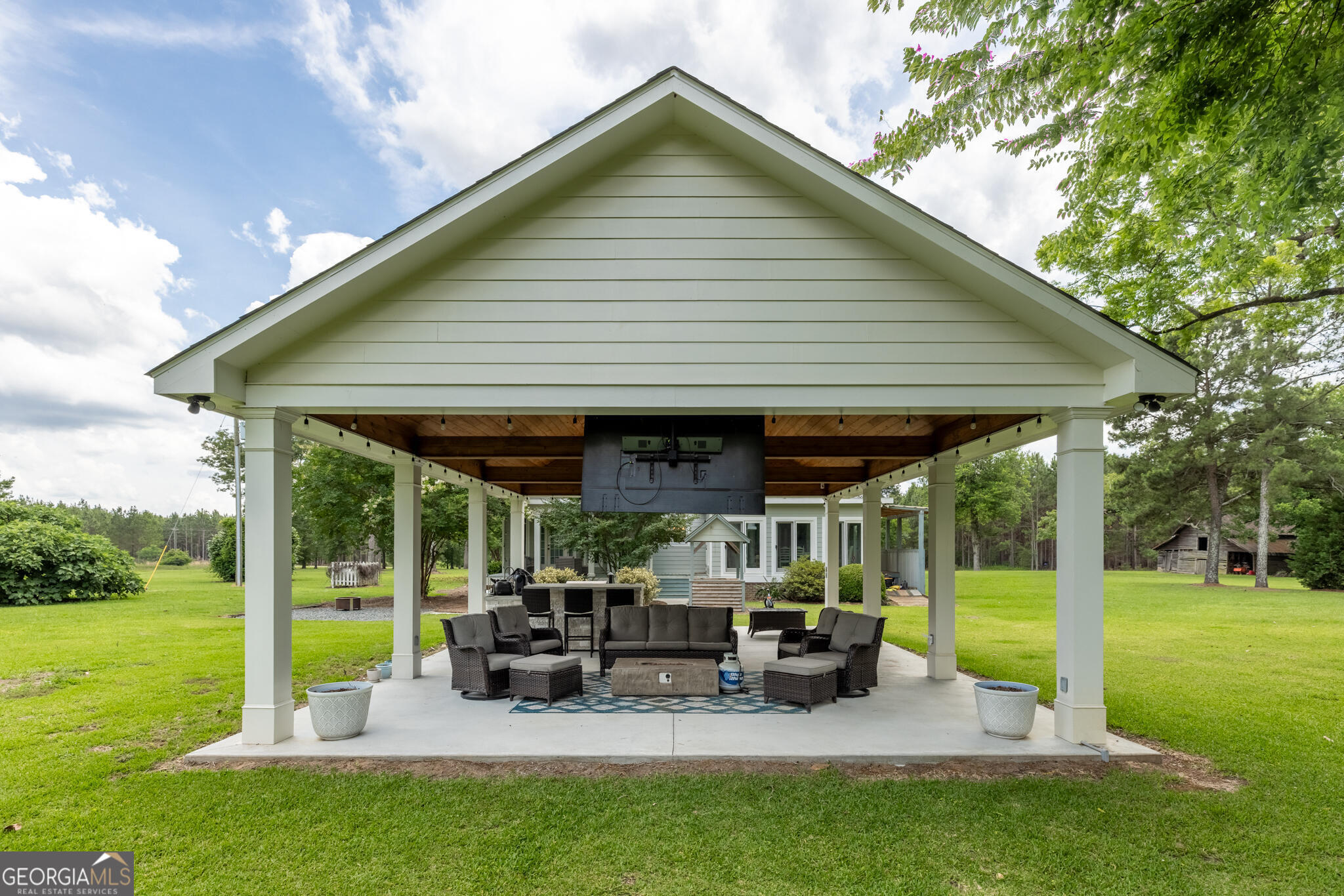 1859 Upper River Road Americus, GA 31709 - Photo 11 of 47 a view of a house with backyard porch and sitting area