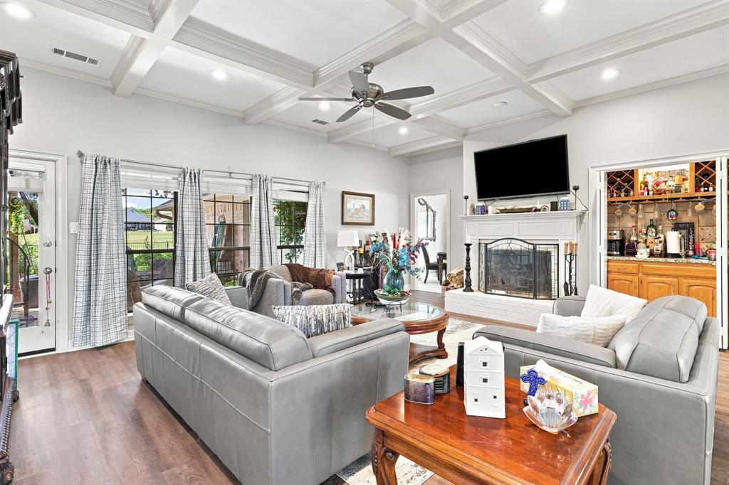 1762 Timber Ridge Circle Corinth, TX 76210 - Photo 5 of 29 Coffered ceiling, recessed lighting, ceiling fan, wood-finish flooring, and a built-in wet bar with cabinetry