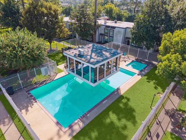 an aerial view of a house with a backyard