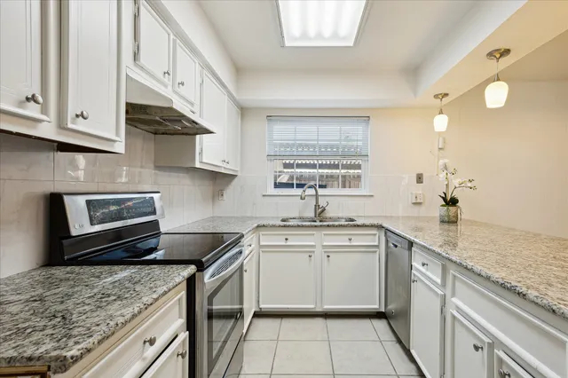 a kitchen with a sink stove and cabinets