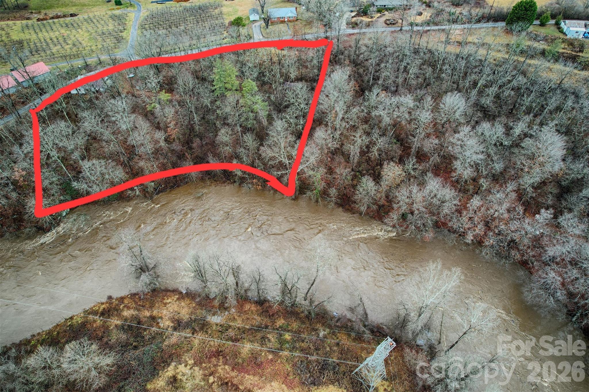 a view of a street with a building and trees in the background