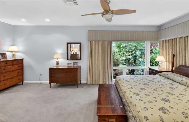 a bed room with a bed and a chair