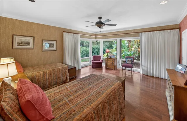 a bedroom with two large bed and a large window