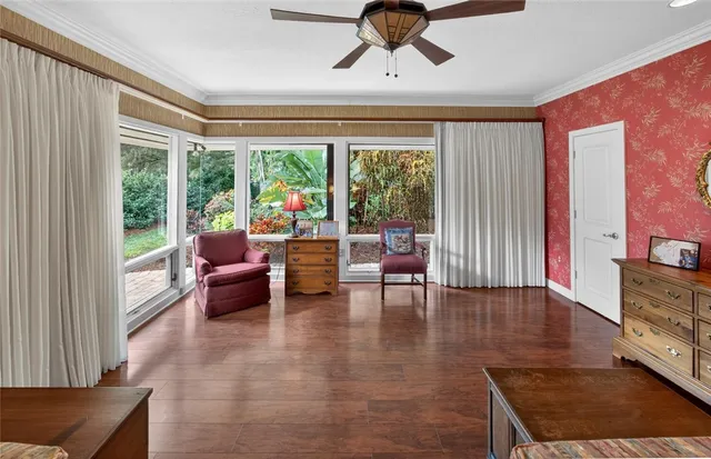 a living room with furniture and a floor to ceiling window
