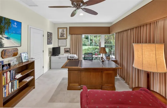 a living room with furniture a large window and a chandelier