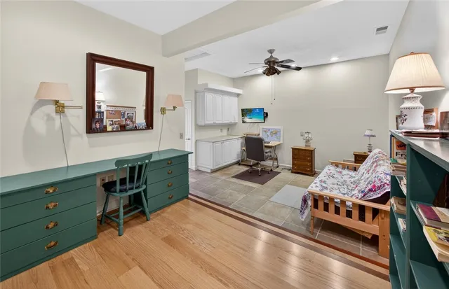 a view of a workspace with furniture and a flat screen tv
