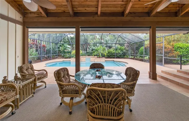 a dining room with furniture a flat screen tv and a large window