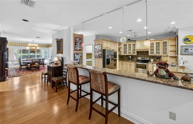 a kitchen with lots of counter and chairs