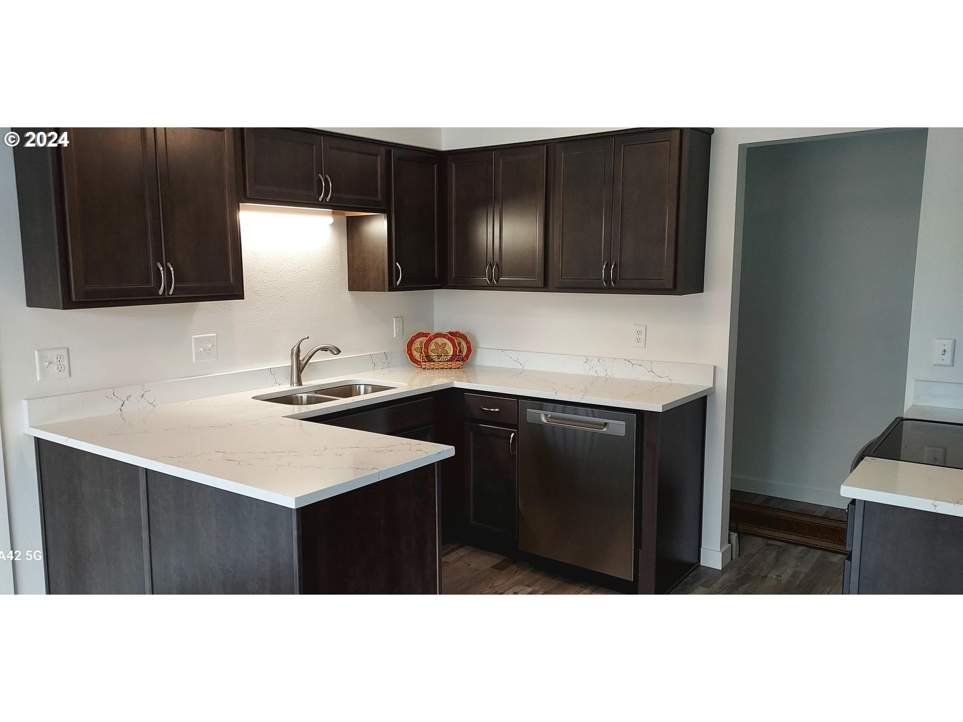 2573 L Street Springfield, OR 97477 - Photo 12 of 22 a kitchen with a sink a microwave a stove and cabinets