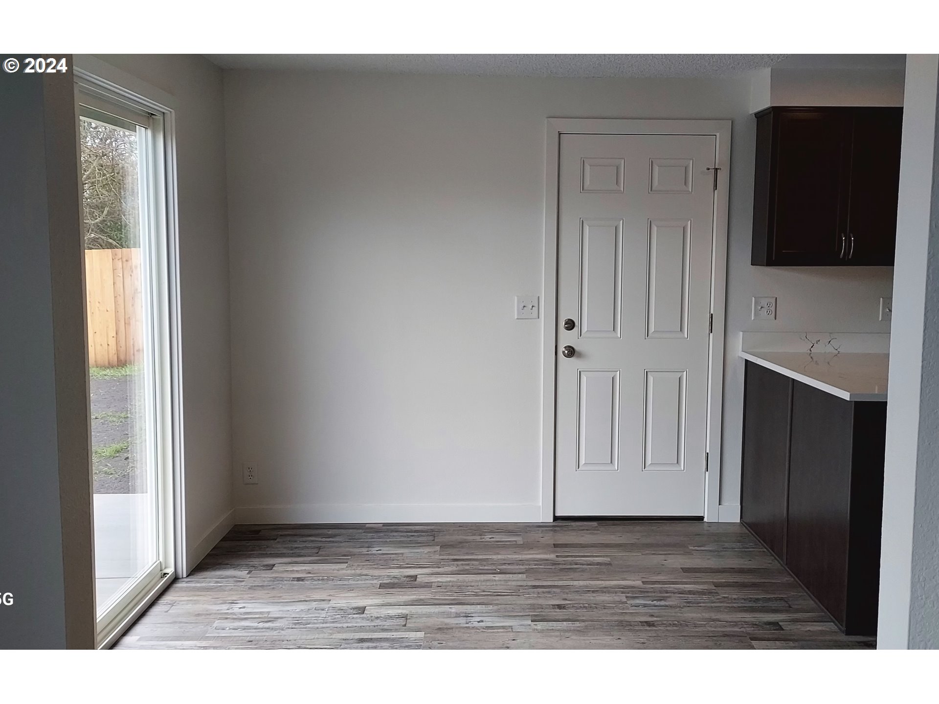 2573 L Street Springfield, OR 97477 - Photo 14 of 22 a view of an empty room with wooden floor and a fireplace