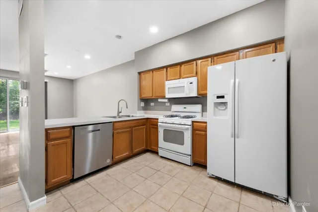 a kitchen with stainless steel appliances granite countertop a refrigerator and a sink