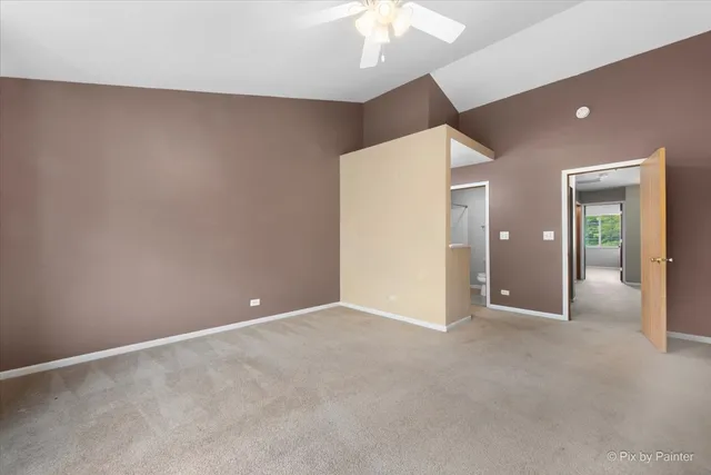 an empty room with fan and entrance