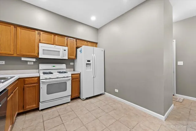 a kitchen with cabinets and white stainless steel appliances