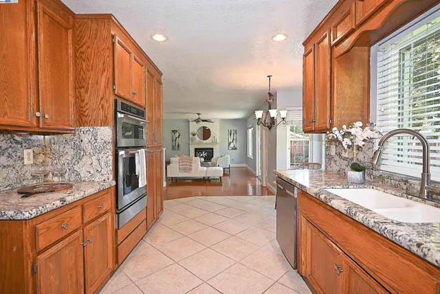 a kitchen with stainless steel appliances a stove a sink and cabinets