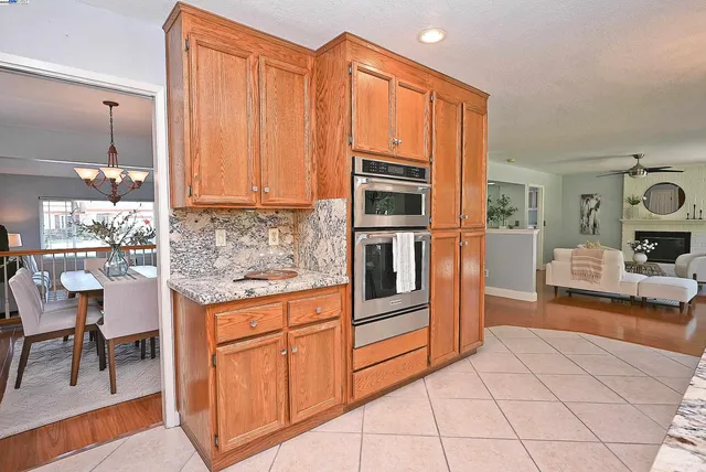 a kitchen with a dining table chairs and white cabinets