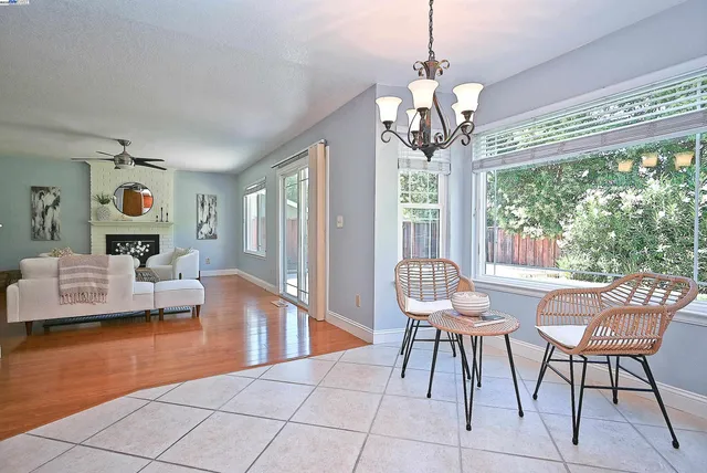 a living room with furniture a fireplace and a large window