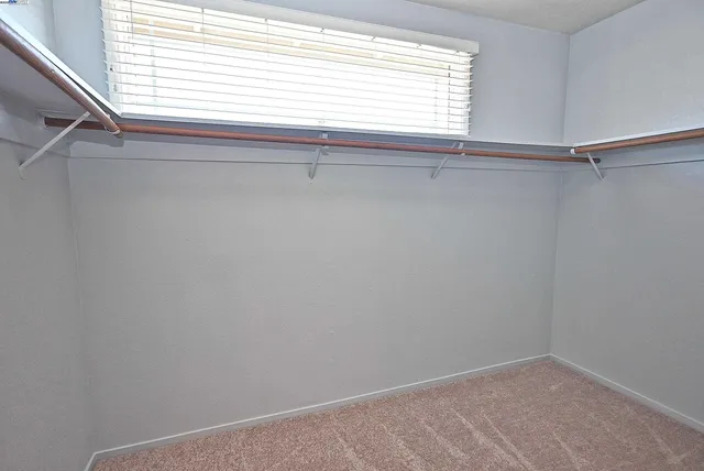 a spacious bathroom with a granite countertop sink and a mirror