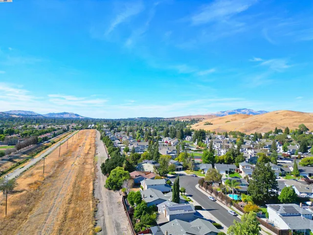 a view of multiple houses with a swimming pool