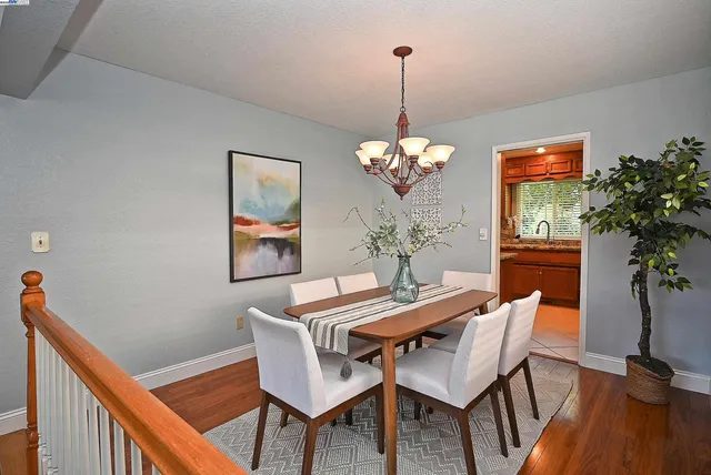 a kitchen with stainless steel appliances granite countertop a refrigerator a stove and a sink