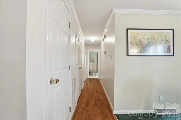 a view of a hallway with wooden floor