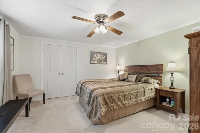 a bedroom with a bed and a lamp