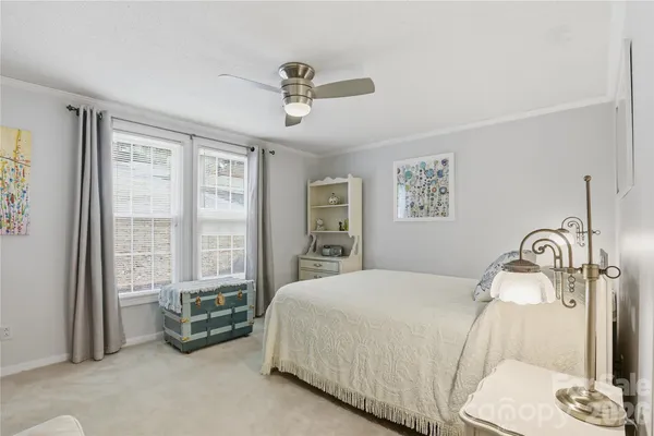 a bedroom with bed and glass door