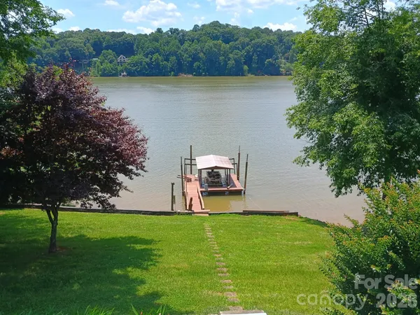 a view of a lake with houses in the back