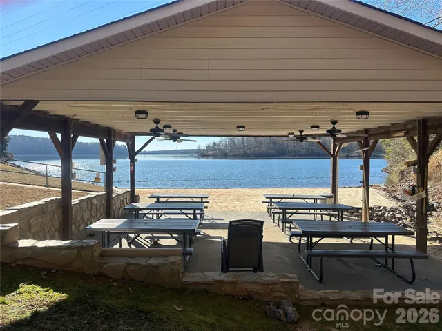 a view of large tree with wooden fence