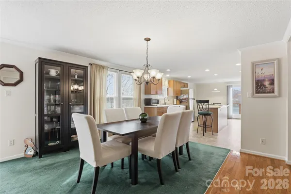 a dining room with furniture window and wooden floor