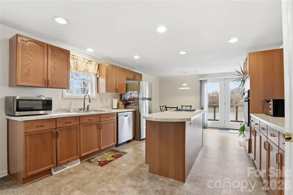 a kitchen with cabinets a sink and appliances