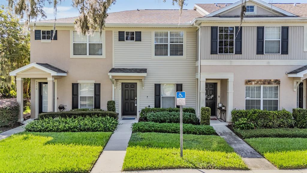 5712 Fishhawk Ridge Drive Lithia, FL 33547 - Photo 1 of 1 a front view of a house with a yard and potted plants
