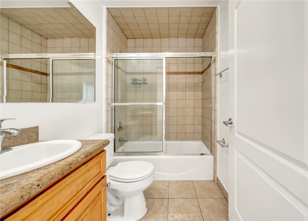 316 South New Hampshire Avenue, Unit 307 Los Angeles, CA 90020 - Photo 12 of 23 a bathroom with a granite countertop sink toilet and shower