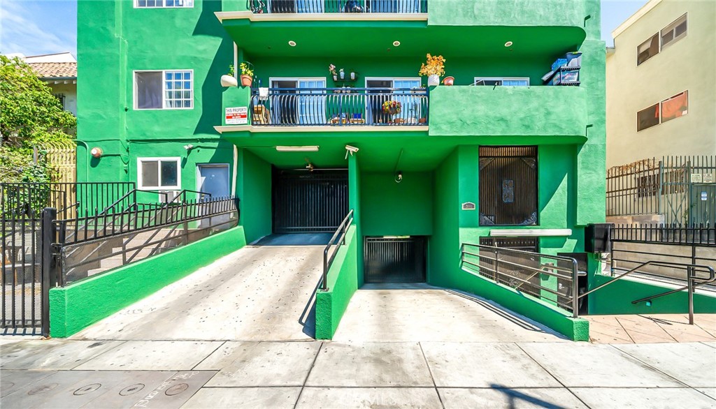 316 South New Hampshire Avenue, Unit 307 Los Angeles, CA 90020 - Photo 15 of 23 a front view of a house with a yard table and chairs